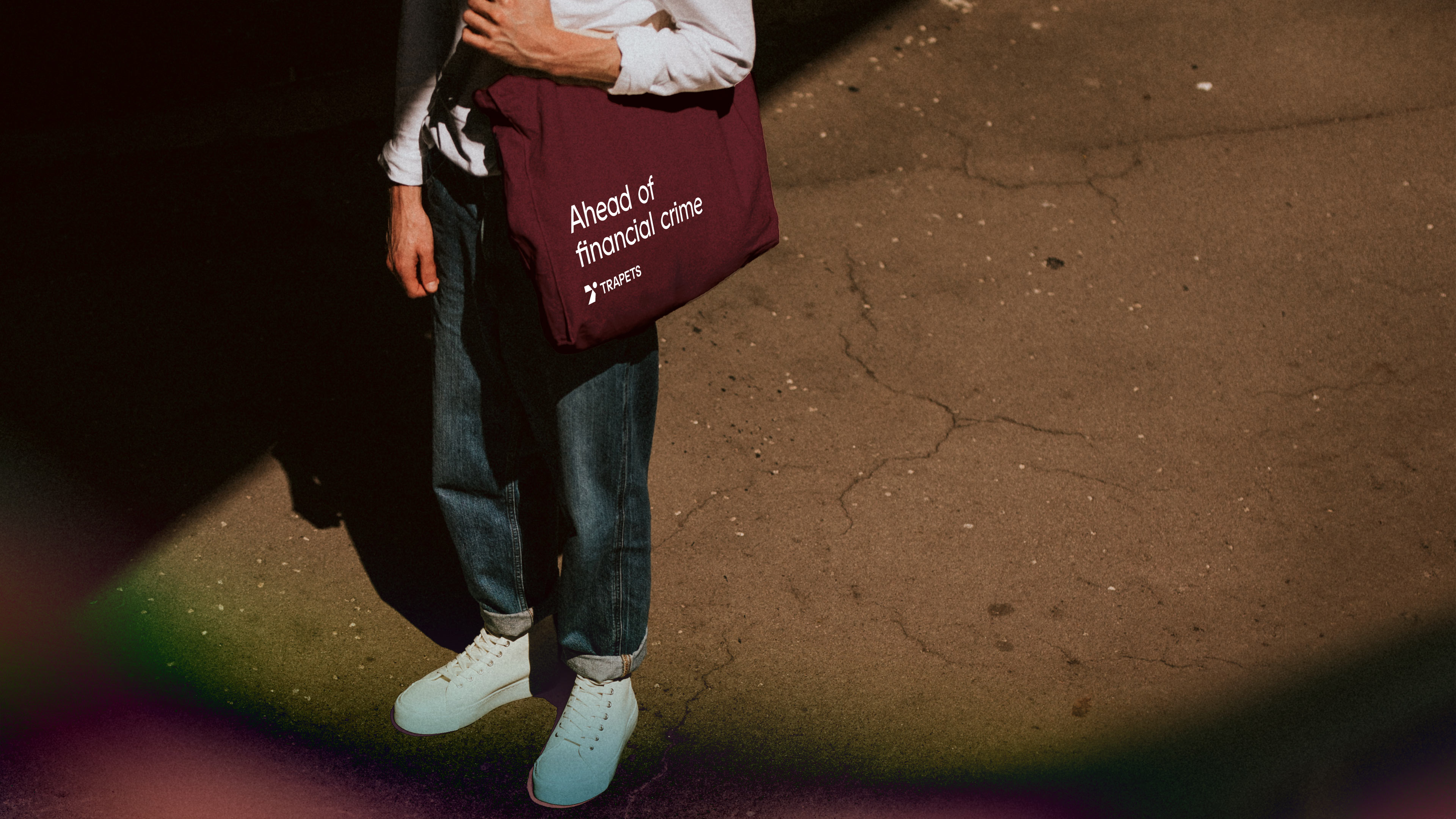 A person with a tote bag with the tagline Ahead of financial crime