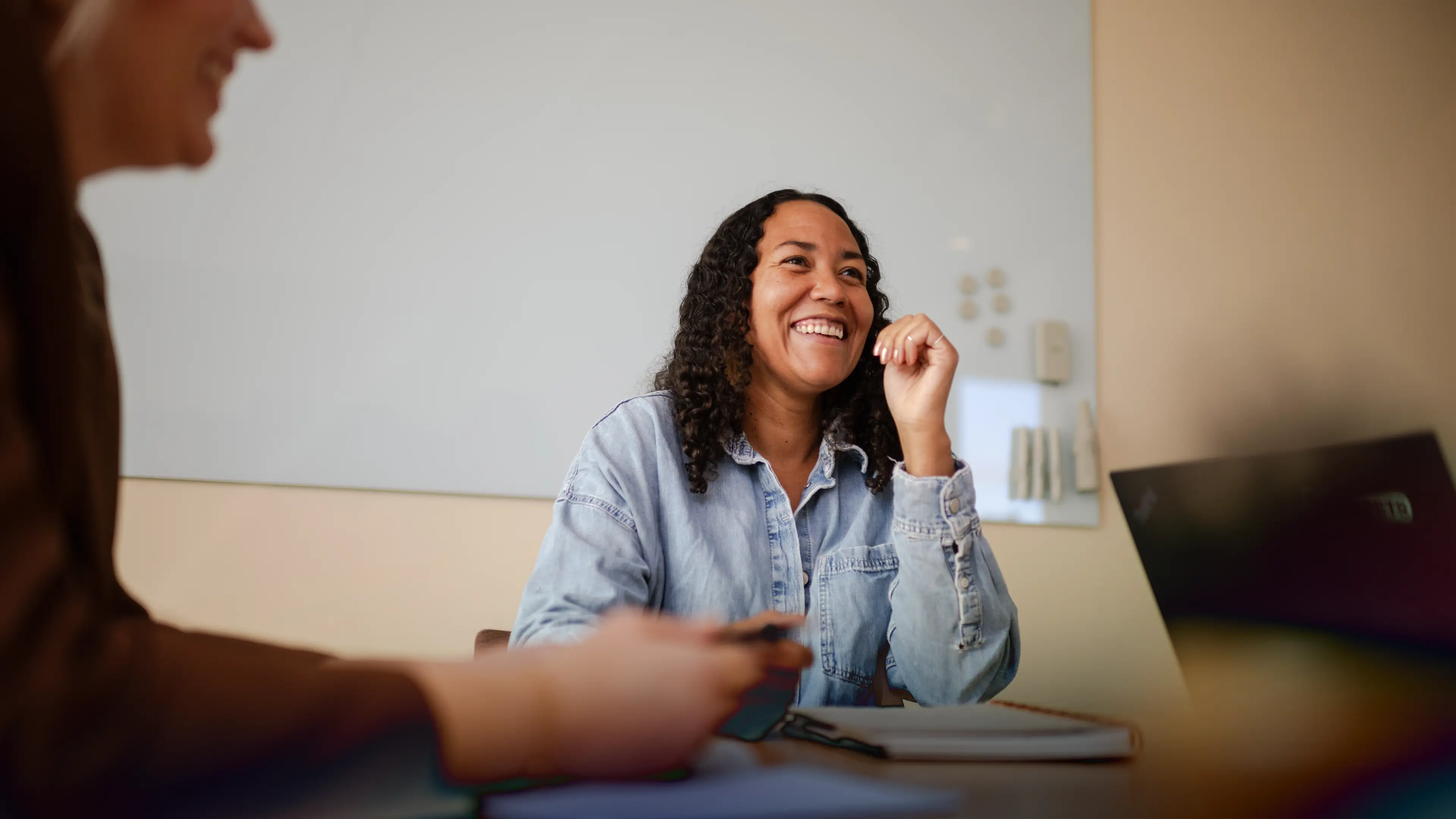 A smiling woman in a meeting